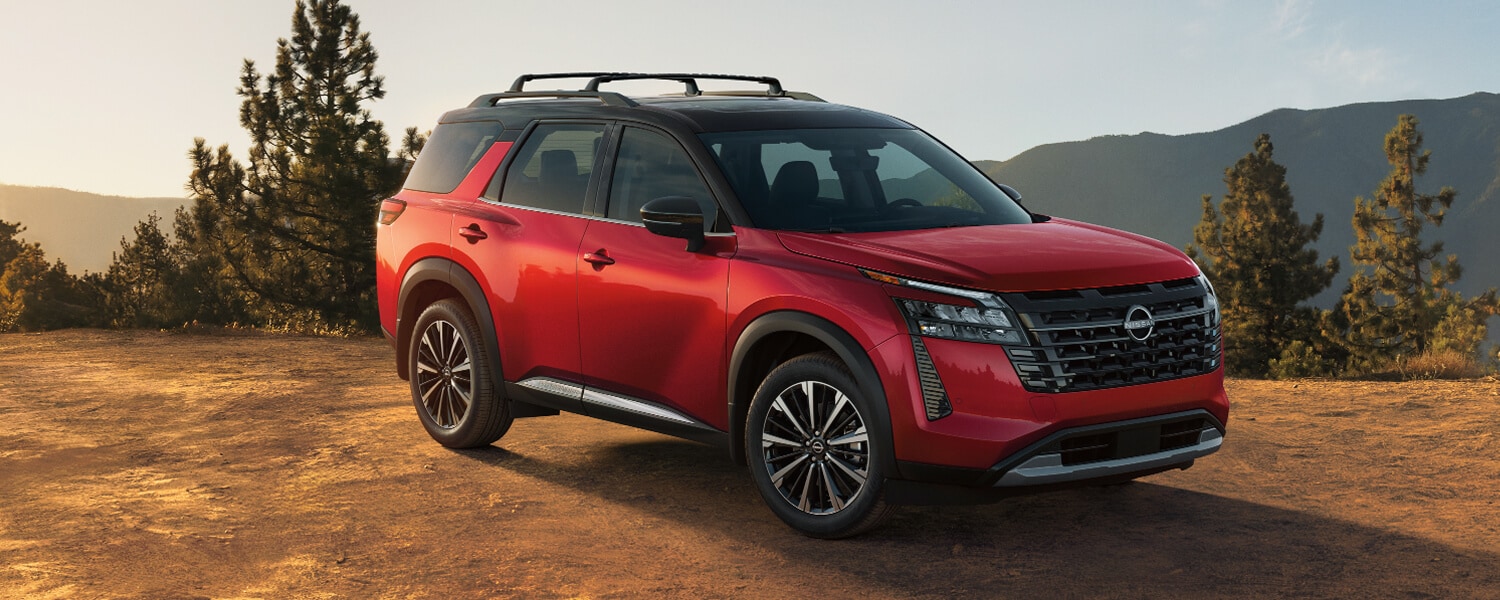 2026-nissan-pathfinder-front-three-quarter-view-red-exterior-mountain-terrain-lightbox-D.jpg